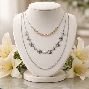 3 Strand Necklace Featuring Beads, Metal Flowers and Metal Chain.